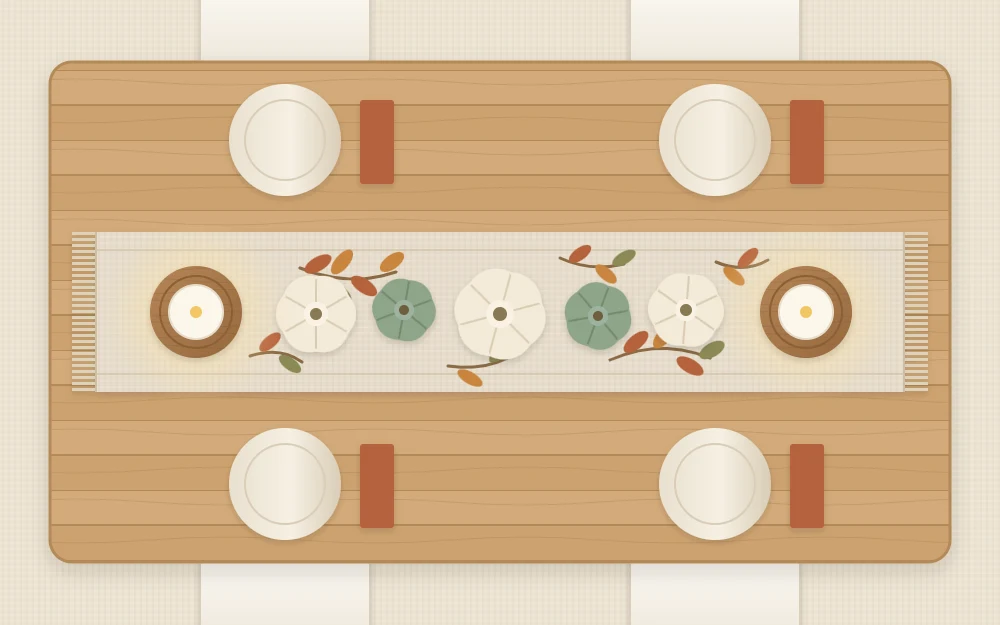 Top-down wooden table with an oat runner, a low line of small cream and green pumpkins, dried leaf sprigs and two flameless candles