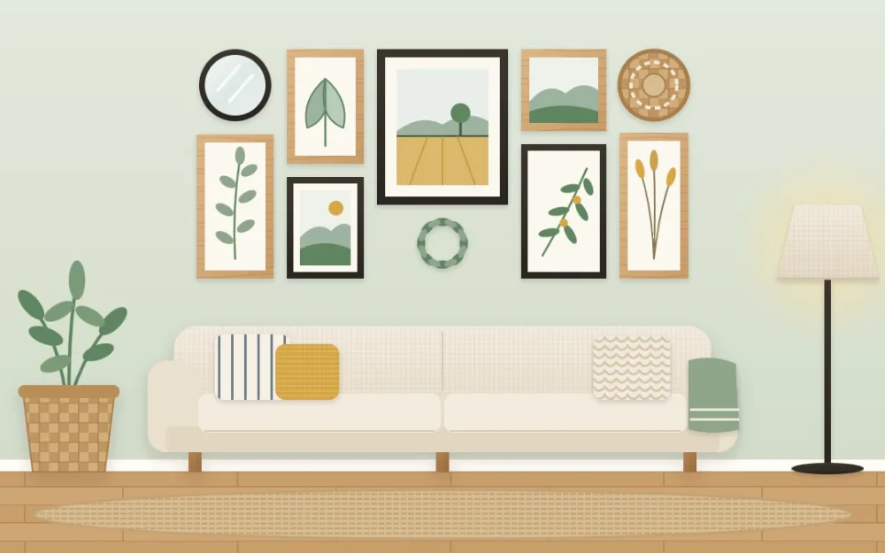 Gallery wall above a linen sofa with seven wood and black framed leaf and landscape pieces, a round mirror, a woven basket and a tiny wreath