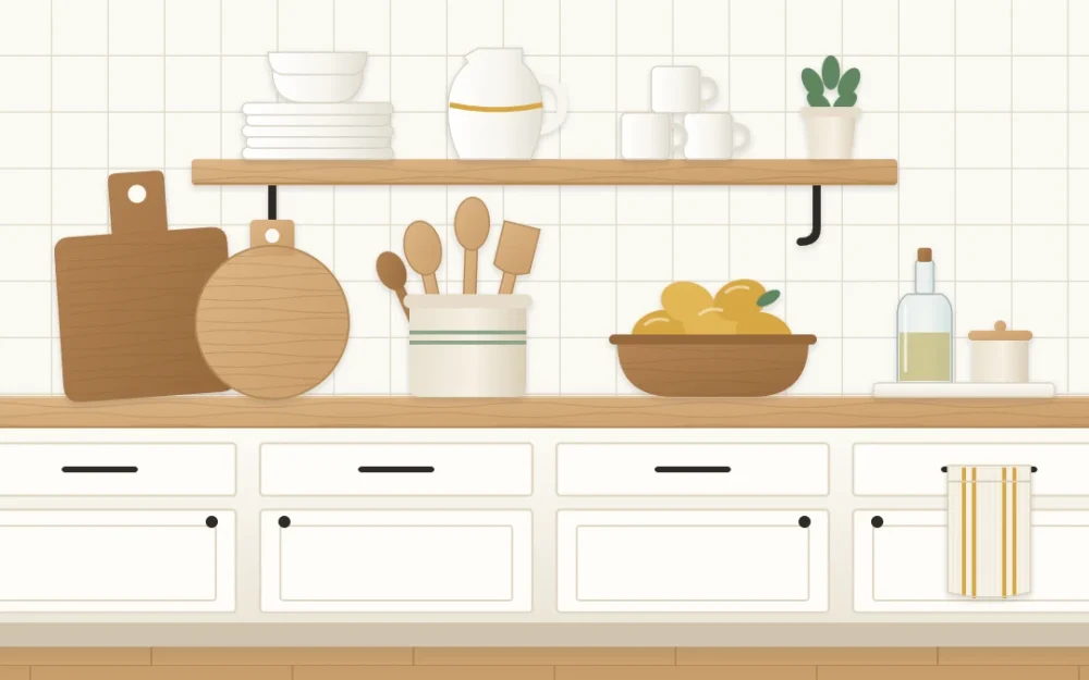 Farmhouse kitchen wall with white lower cabinets, a wooden countertop, two leaning cutting boards, a crock of spoons, a bowl of lemons and a striped towel