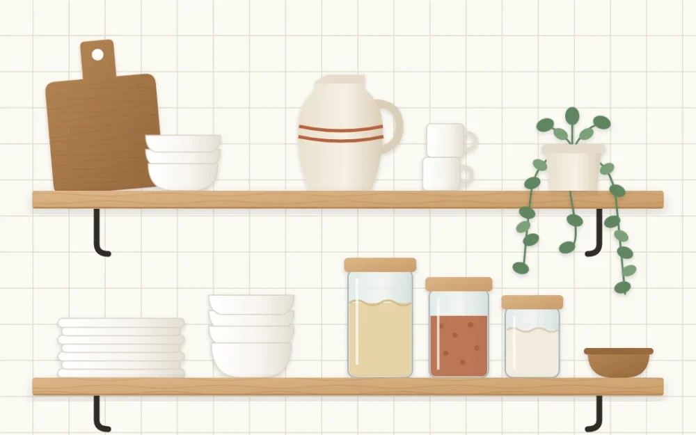Two wooden open shelves on a white tiled kitchen wall with stacked white dishes, glass jars, a leaning board, a trailing plant and a stoneware pitcher