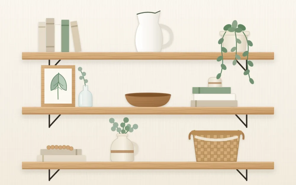 Three thick wooden wall shelves styled with neutral books, a white pitcher, a trailing plant, a framed leaf sketch, a wooden bowl and a basket