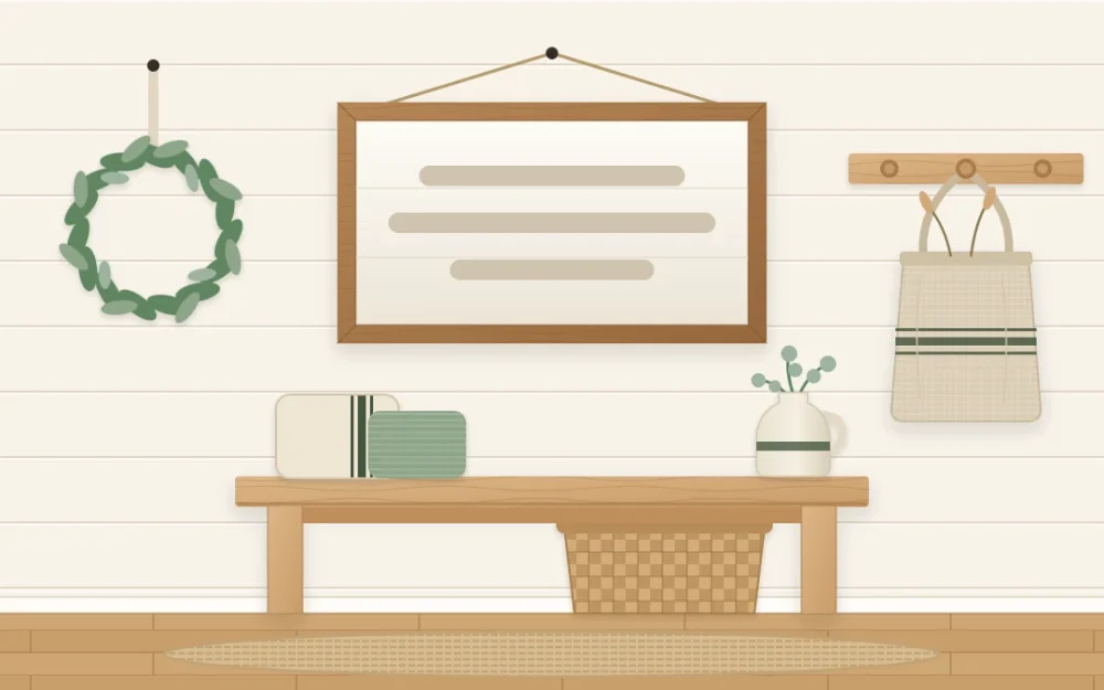 A plain wood-framed white board with three soft bars in place of lettering, hanging above a bench beside a small wreath and a linen bag on a peg